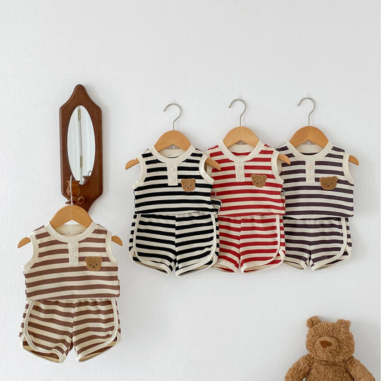 Set of four striped sleeveless baby outfits in brown, black, red, and purple hanging on wooden hangers.