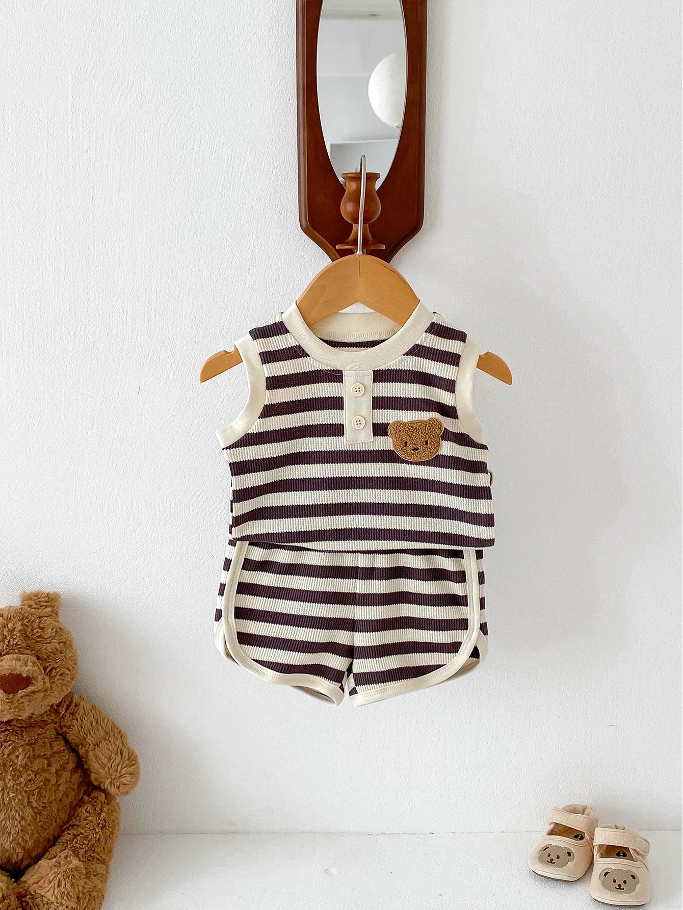 MILANCEL 2024 baby sleeveless set featuring striped tee and shorts, displayed with a teddy bear and shoes.