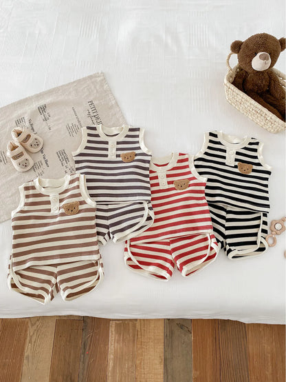Four striped MILANCEL baby sleeveless sets in beige, gray, red, and black on a white bedspread, perfect for infants.